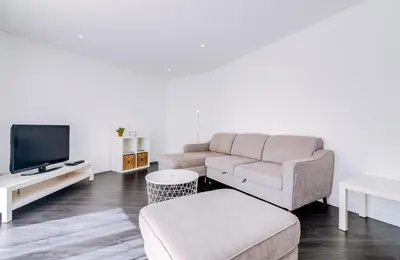 a living room with a couch and a tv at AL - Apartamento Terracos da Falesia in Vilamoura