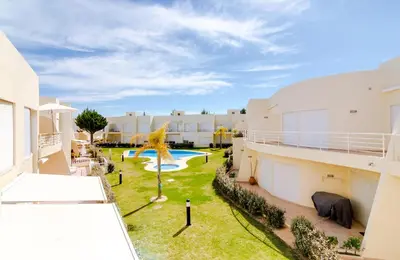 an apartment building with a yard with a swimming pool at AL - Apartamento Terracos da Falesia in Vilamoura
