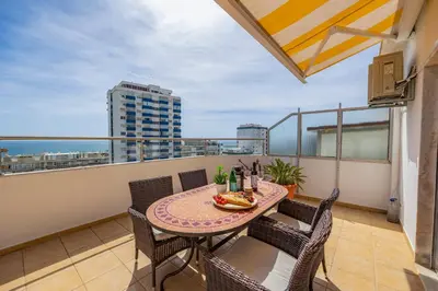 a balcony with a table and chairs on a balcony at Seaview Penthouse in Algarve with Spacious Terrace in Quarteira
