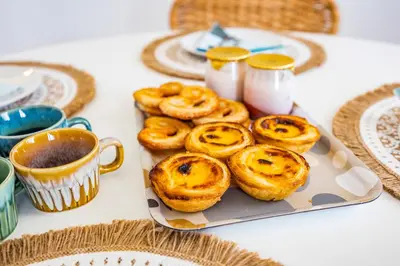 a plate of pretzels on a table with a cup of coffee at Seaview Penthouse in Algarve with Spacious Terrace in Quarteira