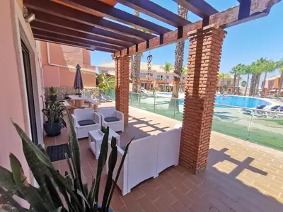 a patio with a view of the pool at a resort at Albufeira Villa Santa Maria in Albufeira
