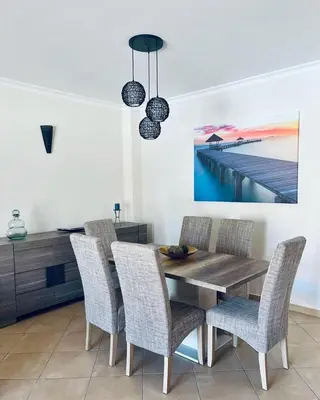 a dining room with a wooden table and chairs at Albufeira Villa Santa Maria in Albufeira