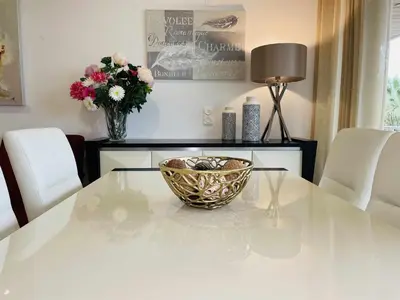 a table with a bowl on top of it with a vase of flowers at Marina Vilamoura Aquamar 104 By Vilamoura Sun in Vilamoura