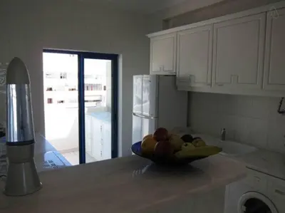 a bowl of fruit on a counter in a kitchen at Oceanides Beachfront Apartments in Quarteira