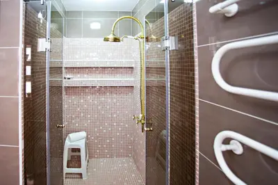 a shower with a glass door in a bathroom at Villa Monaco in Faro