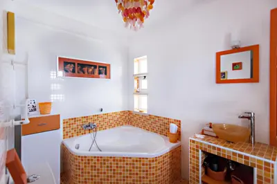 a bathroom with a bath tub in a room at Villa Monaco in Faro