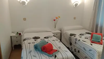 a bedroom with two beds with towels on them at Apt Cardoso 3 ao lado da Praia Peneco in Albufeira