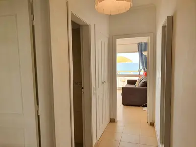 a hallway with a room with a view of the ocean at T1 Praiamar 3 Vista Fabulosa in Quarteira