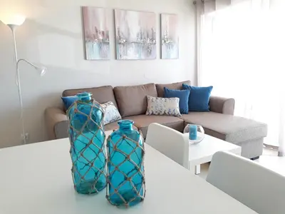 two blue vases sitting on a table in a living room at T1 PraiaMar RC com Ar-Condicionado in Quarteira