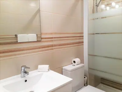 a bathroom with a sink and a toilet and a mirror at T1 PraiaMar RC com Ar-Condicionado in Quarteira