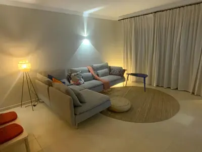 a living room with a couch and a table at Corcovada 37 in Albufeira