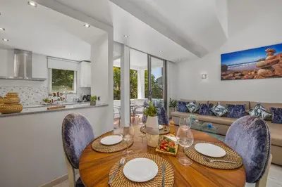 a dining room with a wooden table and chairs at Renovated Vilamoura Penthouse Near Marina & Beach in Vilamoura