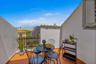 a patio with a table and chairs on a balcony at Renovated Vilamoura Penthouse Near Marina & Beach in Vilamoura