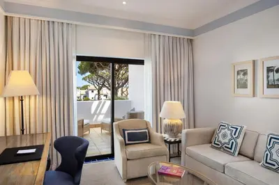 a living room with a couch and a table at Pine Cliffs Hotel, a Luxury Collection Resort, Algarve in Albufeira