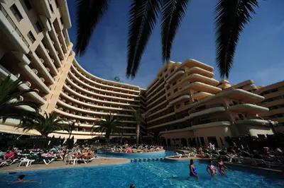 a resort with a swimming pool and two large buildings at Vila Gale Marina in Vilamoura