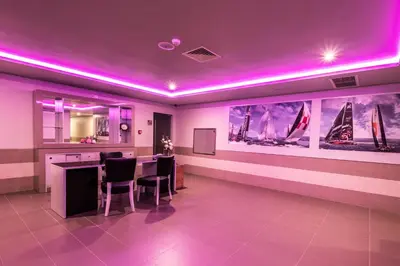 a room with purple lighting and a table and chairs at Vila Gale Cerro Alagoa in Albufeira