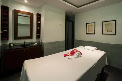 a bedroom with a bed with a sink and a mirror at Vila Gale Ampalius in Vilamoura