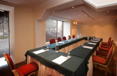 a conference room with a long table and chairs at Vila Gale Ampalius in Vilamoura