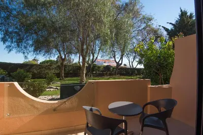 a resort with a large swimming pool in a park at Vila Gale Atlantico in Albufeira