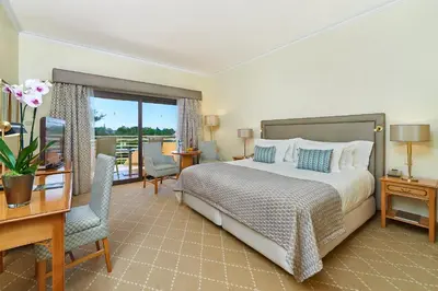 a hotel room with a bed and a desk and a desk at Hotel Quinta do Lago in Quinta do Lago