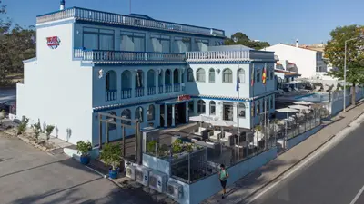 a blue and white building on the side of a street at Hotel Santa Eulália Bay in Albufeira