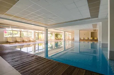 a large swimming pool in a building with a swimming pool at Alfagar Village in Albufeira