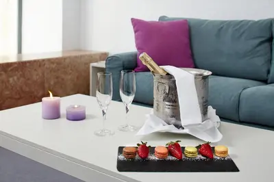 a table with wine glasses and strawberries and candles at Occidental Faro in Faro