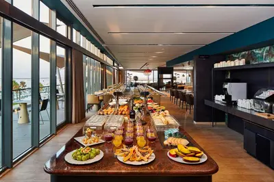 a buffet line with food and drinks on a table at Occidental Faro in Faro