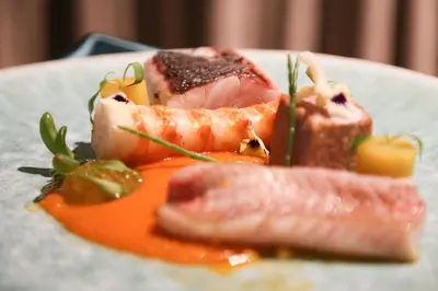 a plate of food with salmon and meat on it at Occidental Faro in Faro