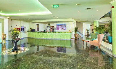 a lobby with a bar in a building at Hotel Baia Grande in Albufeira