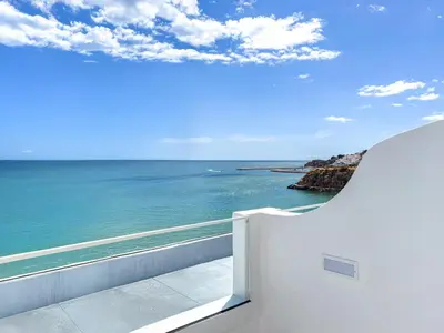 a view of the ocean from the balcony of a house at Hotel Sol e Mar Albufeira - Adults Only in Albufeira
