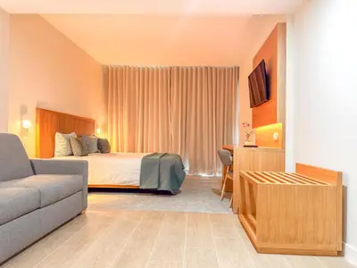 a hotel room with a bed and a couch at Hotel Sol e Mar Albufeira - Adults Only in Albufeira