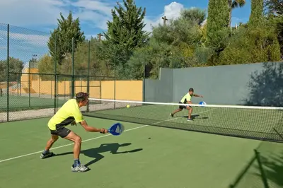 two men playing tennis on a tennis court at Alfagar Alto da Colina in Albufeira