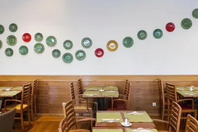 a dining room with tables and plates on the wall at Alfagar Alto da Colina in Albufeira