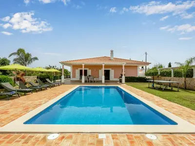 a swimming pool in front of a house at Villa Villa Pescada by Interhome in Albufeira