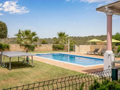 a backyard with a ping pong table and a swimming pool at Villa Villa Pescada by Interhome in Albufeira