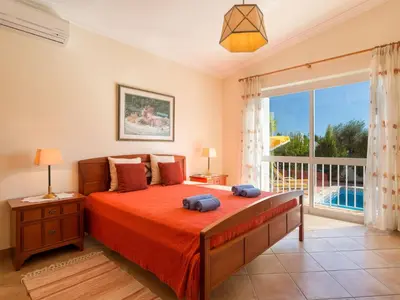 a bedroom with a bed and a large window at Villa Villa Natura by Interhome in Guia