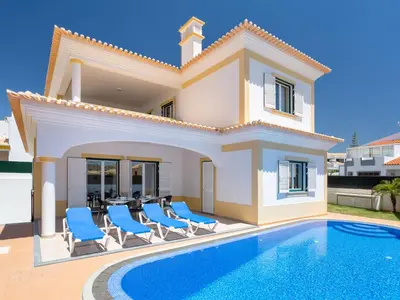 a villa with a swimming pool in front of a house at Villa Colibri by Interhome in Patroves