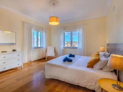 a bedroom with a large white bed and two windows at Villa Colibri by Interhome in Patroves
