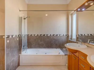 a bathroom with a tub and a sink at Villa Colibri by Interhome in Patroves