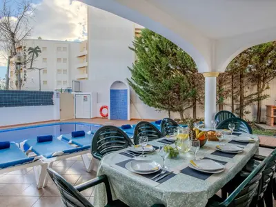 a table and chairs on a patio with a pool at Villa Colibri by Interhome in Patroves