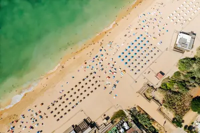 an overhead view of a beach with chairs and umbrellas at Monica Isabel Beach Club in Albufeira