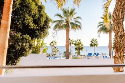 a table with a plate of food and a view of the beach at Monica Isabel Beach Club in Albufeira