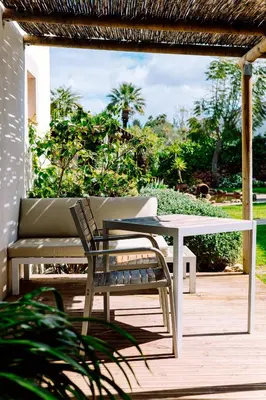 a table and chairs sitting outside of a house at Casa do Alto in Vilamoura
