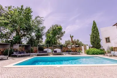 a living room with a couch and a table at Casa do Alto in Vilamoura