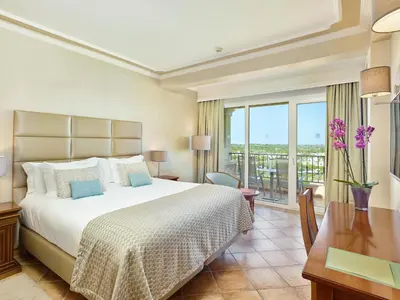 a hotel room with a bed and a desk and window at Ria Park Hotel & Spa in Vale do Lobo