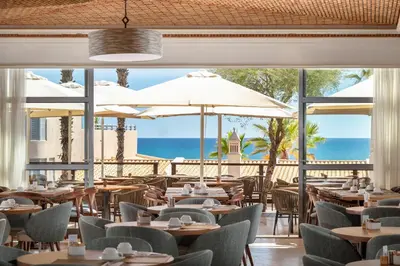 a living room filled with furniture and a fireplace at Grande Real Santa Eulalia Resort & Hotel Spa in Albufeira