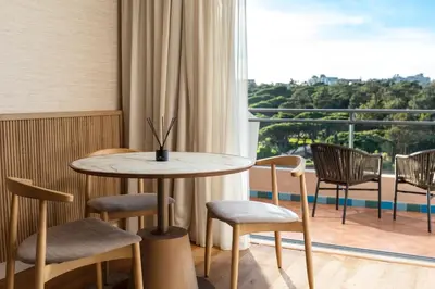 a living room with a couch and a table at Grande Real Santa Eulalia Resort & Hotel Spa in Albufeira