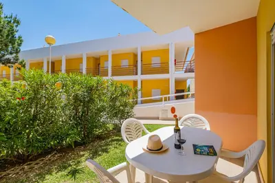 a table and chairs with a hat on top of a building at Pool&Beach in Encosta de São José in Albufeira