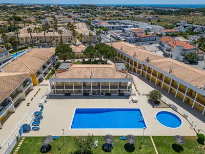 an aerial view of a building with a swimming pool at Pool&Beach in Encosta de São José in Albufeira